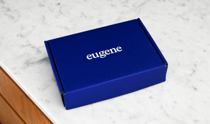 Blue carrier screening test kit box on marble table with eugene logo